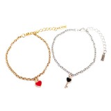 Maria King Ezüst-arany színű páros karkötő piros szív és fekete kulcs charmmal